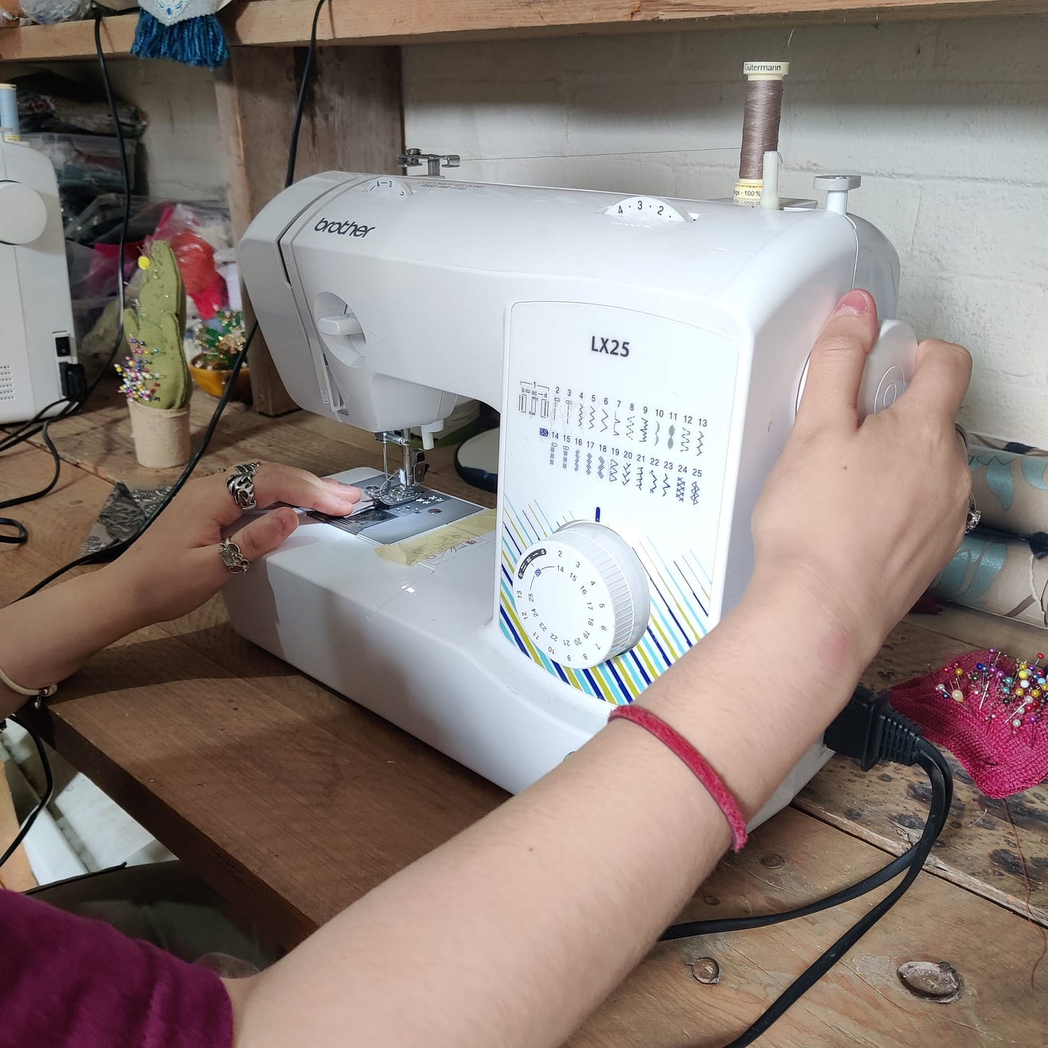 Volunteers is keeping hands on a sewing machine. Preparing to sew.