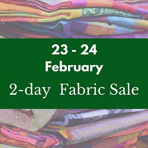 A picture of colourful and soft fabrics on the shelves. The text is saying: 2-day fabric sale! Friday 23 and 24 February